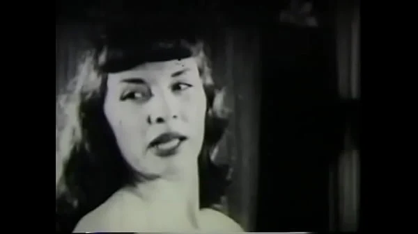 Hottie with bangs stripping on camera in vintage film 50s