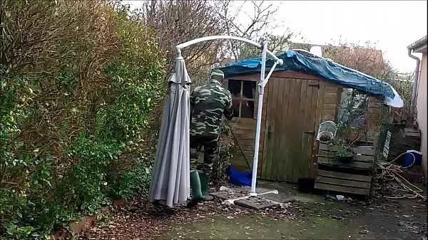 vintage – smoking guy in camo and rubber boots undressing